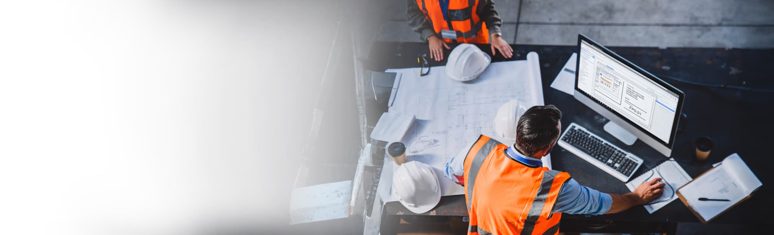 overhead shot of construction worker looking at monitor