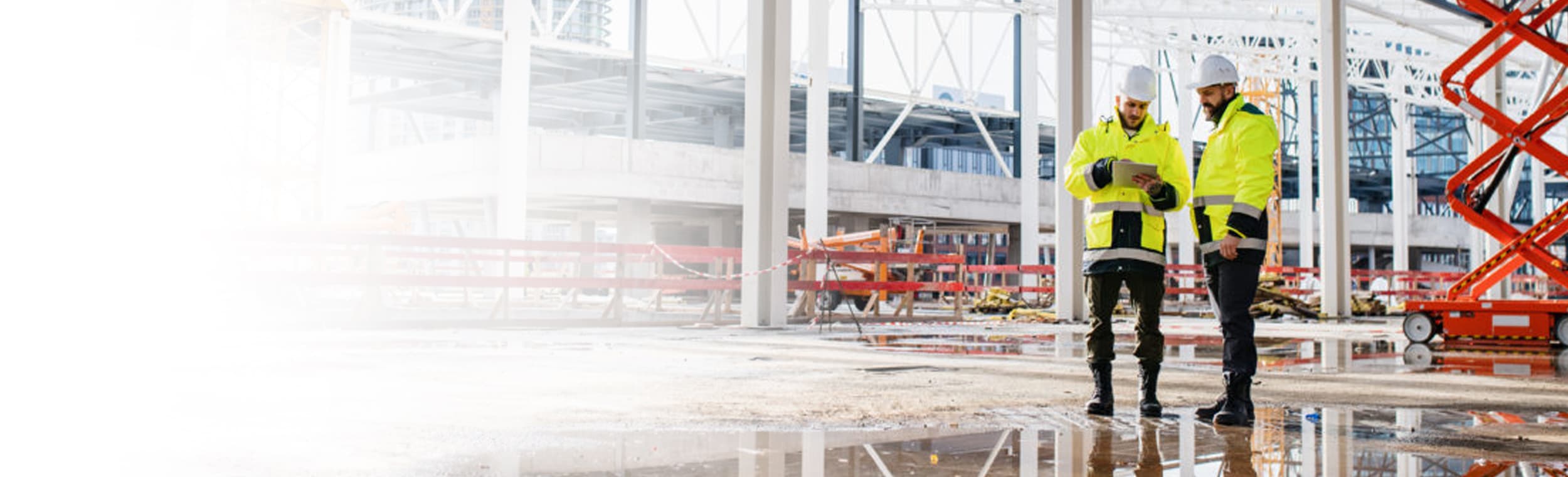 Two construction executives looking at an iPad on a site 1200x800