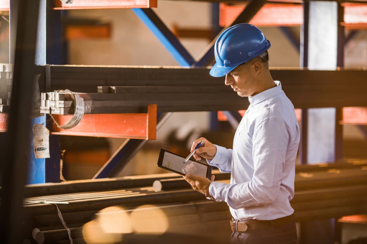 Construction worker looking at an iPad 1200x800